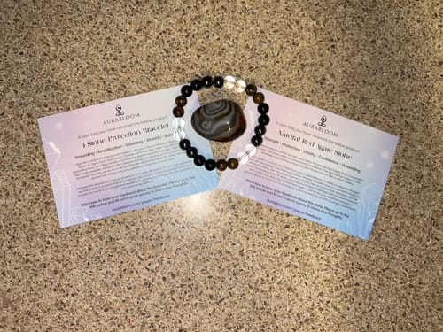 Customer's beaded bracelet and polished agate stone from their VIP Crystal Club box, displayed on info cards.