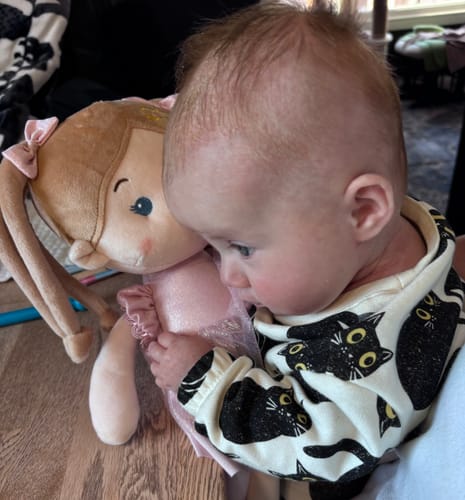 A customer's baby hugging their personalized Leyadoll soft plush doll.