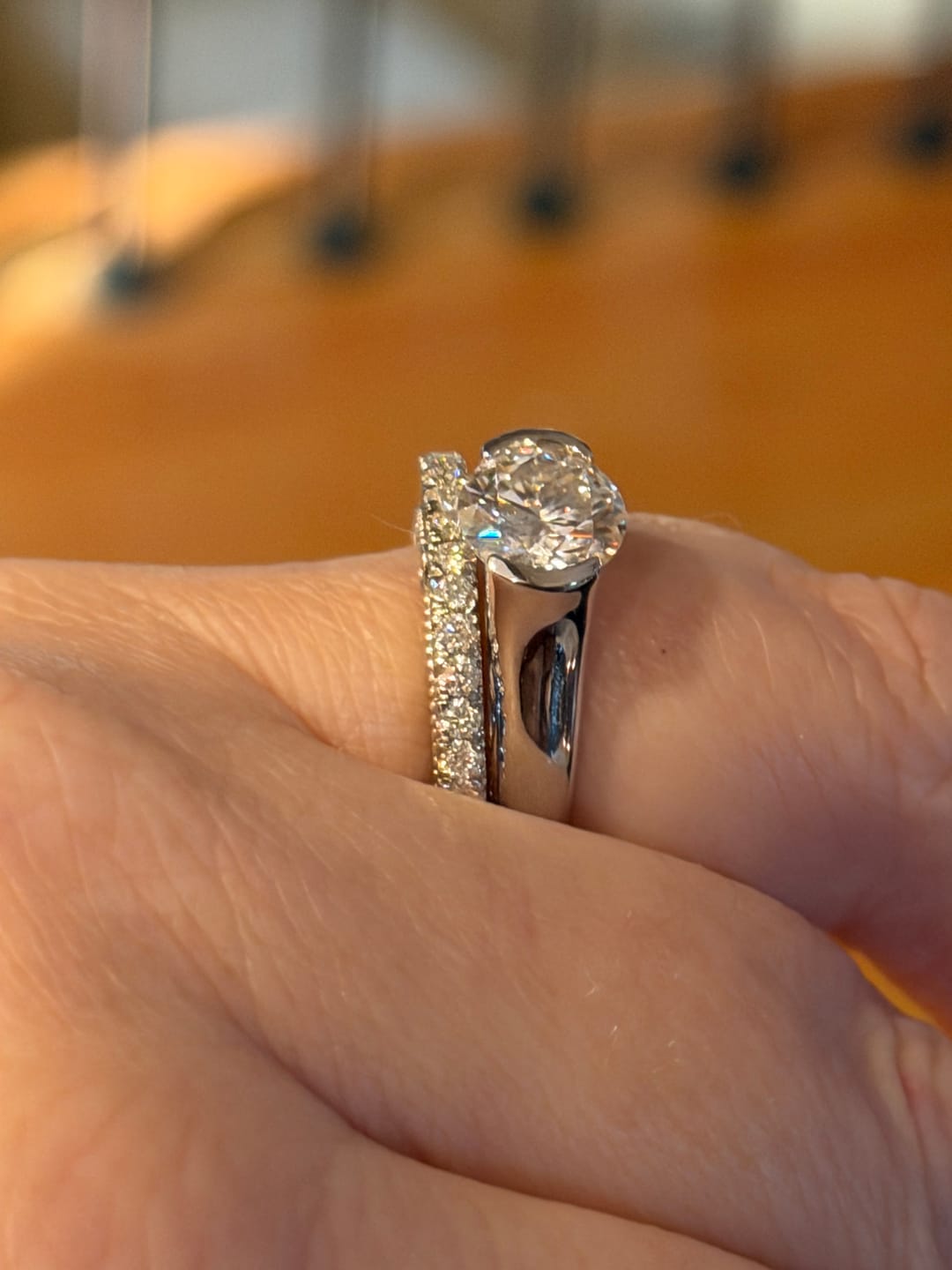 Customer photo review of Solitaire Moissanite Half Bezel Set Sterling Silver Engagement Ring