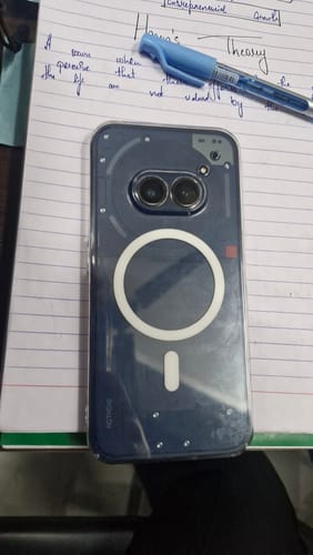 Customer's Anti Yellow Magsafe Clear Transparent Case on a Nothing (PH 2A) phone, lying on a notebook.