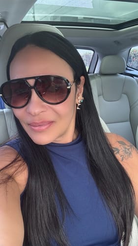 Cliente usando os Óculos Veneza com armação grande e lentes degradê dentro de um carro.