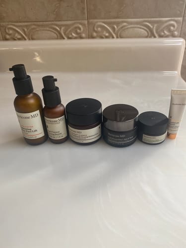 Customer's Face & Neck Deluxe System products arranged on a white bathroom counter.