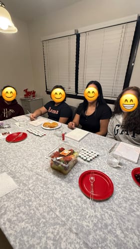 Customer and nieces sitting at a table prepared for a paint night with the Paint by Numbers Christmas Bundle.