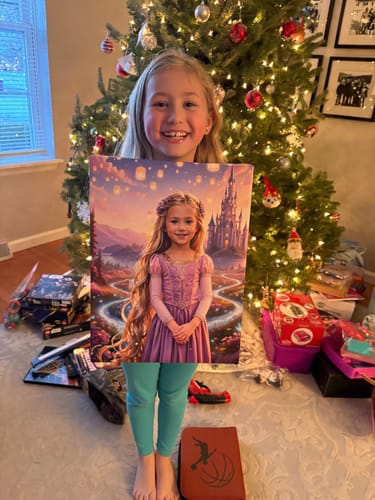 A customer's Golden Hair princess portrait being held by a smiling child in front of a Christmas tree.