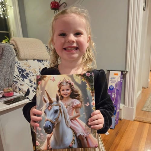 A happy young girl holding her 'The Enchanted Unicorn Princess' canvas print from a reviewer.