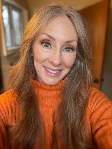 Customer smiling in a selfie showing her full, chocolate Fluffy Lite Gossamer Lashes.