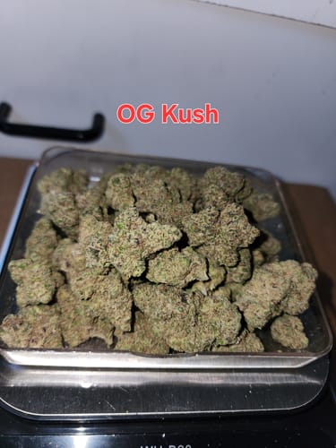 Customer's OG Kush THCA Flower smalls in a tray on a digital scale.