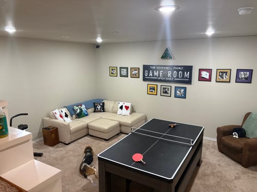 Customer's large Tailored Boost sign hanging as a centerpiece on their game room's focal wall.