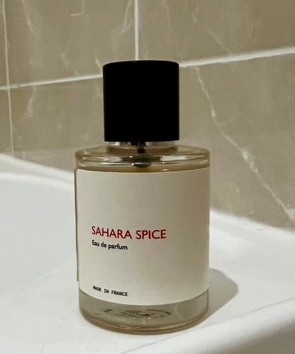 Customer's bottle of Sahara Spice eau de parfum resting on a white ledge in a bathroom.