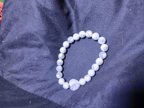 Customer's beaded Howlite bracelet with a heart stone, shown on a dark background.