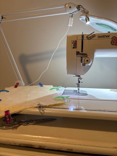 Customer's Sew Creative Flexible Light positioned over a sewing machine, brightly illuminating the needle and fabric.