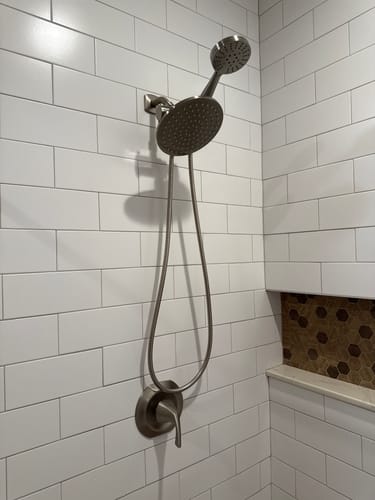 Customer's 3-Spray Dual Shower Head Set installed on a white tiled wall in their bathroom shower.