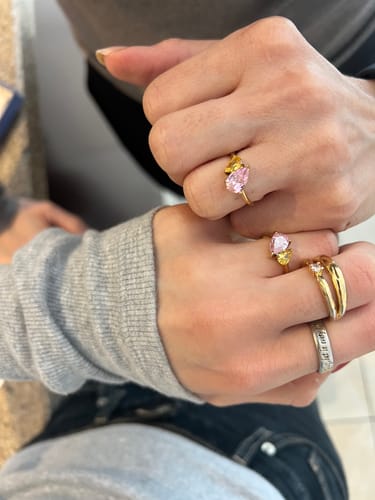 Customer and their mom wearing matching Leesha Birthstone Rings with pink and yellow stones.