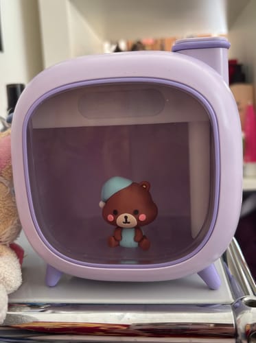 Reviewer's lavender ATEEZ JONGHO CLOUDY LIGHT used as a nightlight, with the cute bear figure lit inside.