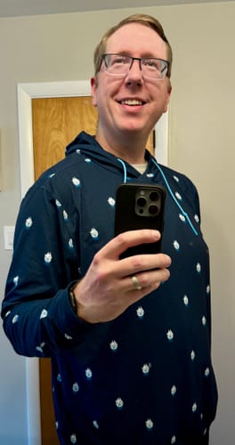 Reviewer wearing the dark blue Star Wars '12 Parsecs' Performance Hoodie, showing off the all-over Millennium Falcon pattern.