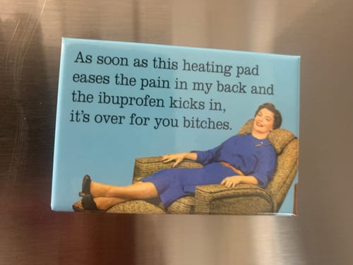 Customer's humorous magnet with a retro-style illustration, seen here on a stainless steel fridge.