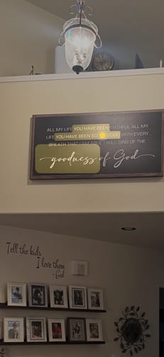Customer's large Tailored Boost wall sign with the phrase 'goodness of God' hanging high on a wall in their home.