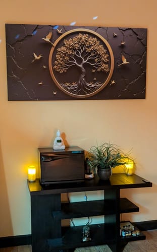Customer's Celtic Tree of Life Wall Art displayed above a console table in a warmly lit room.