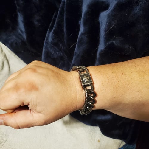 Customer wearing the antiqued Knights Templar Bracelet on their wrist, showing the fit and cross clasp.