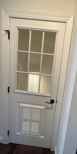 Customer's white interior door after installing the 9 Lite Glass and Frame Kit on the upper half.