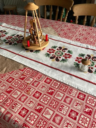 Customer's Festive Patchwork Christmas Cotton Fabric on a table, showing the detailed red and cream pattern with a kangaroo.