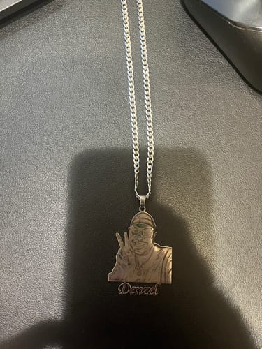 Customer's custom photo engraved pendant necklace with a detailed picture of a person and the name 'Denzel' below.