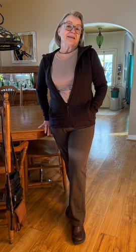 Reviewer standing in a home wearing the Emerson Straight Leg Pants in Bracken with a dark zip-up hoodie.