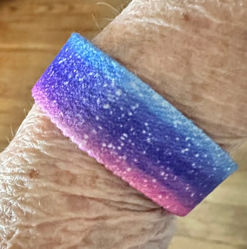 Close-up of the colorful, starry Trust God Bible Verse Bracelet on a reviewer's wrist.