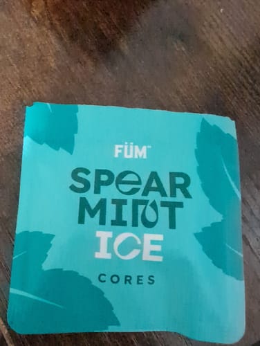 Customer showing the teal packaging for their Spearmint Ice Cores on a wooden surface.