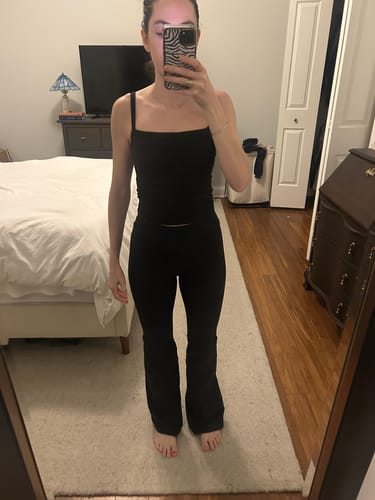 Reviewer's full-length front view of the flared black Leisure Pant.