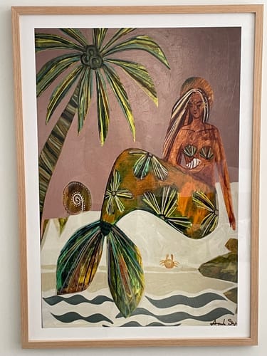 Customer's 'Release it To The Sea' art print hanging on a wall in a light oak frame.