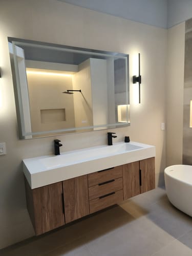 Customer's installed Breton Floating Vanity with a wood-grain finish and white double sink in a modern bathroom.