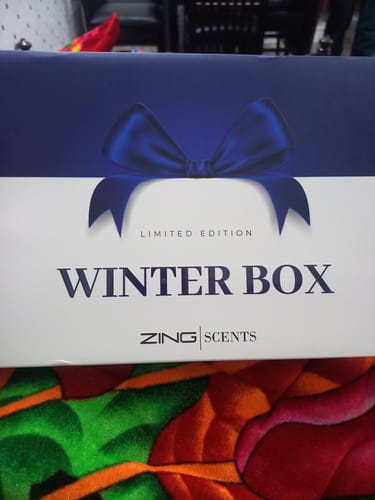 Customer's 'Limited Edition Winter Box' packaging for the OUD Supreme BUNDLE, shown on a colorful surface.