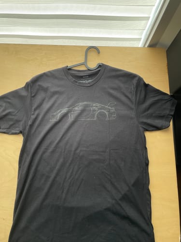 Customer's black 80Eighty® DCG #85 Shirt with a grey car outline graphic, shown on a hanger.