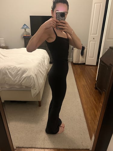 Reviewer's side profile, showing the supportive fit of the black Leisure Pant.