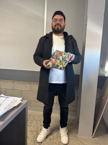 Customer holding the open Chocolate Variety Pack, with the colorful assortment of chocolates visible.