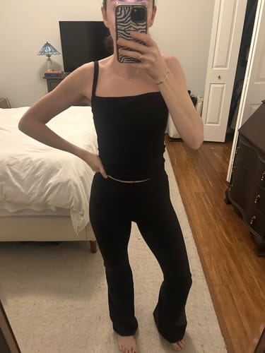 Customer's three-quarter front view of the high-waisted, black Leisure Pant.