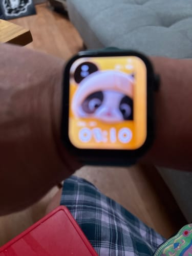 Close-up: Customer's Gard Pro Health Smartwatch 3 on their wrist with a bright, blurry display showing a panda.