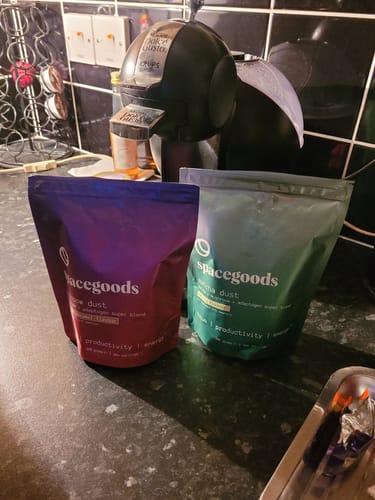 Customer's two pouches of Rainbow Dust, Caramel Coffee and Matcha flavors, on a kitchen counter.