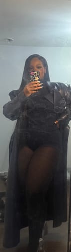 Close-up: Reviewer's mirror selfie showing the fit of the black Butter Turtleneck Contour Bodysuit under a coat.