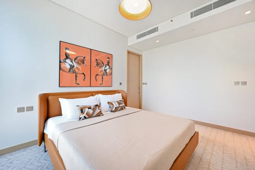 Customer's Prague King Size Bed with a brown leather frame, shown fully assembled and made in a bright bedroom.