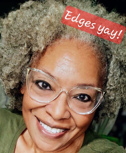 Customer showing her fuller hairline with gray curly hair after using the Scalp Stimulator.