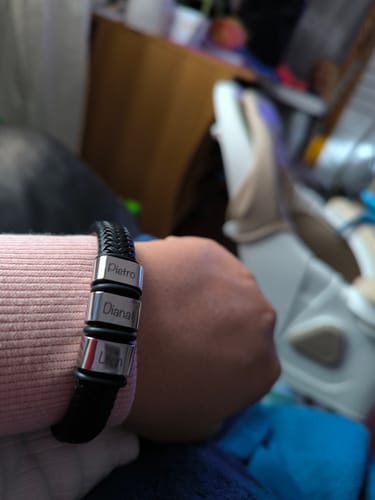 Close-up of a customer's wrist wearing the braided Viking bracelet with three personalized beads.