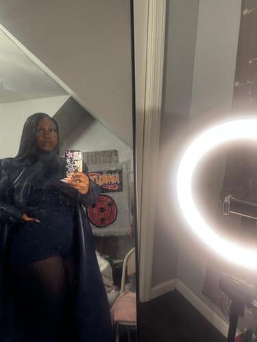 Reviewer posing in the black Butter Turtleneck Contour Bodysuit, seen in a mirror selfie with a ring light.