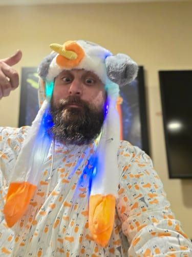 Reviewer wearing the Finding Nemo 'MINE!' performance hoodie with its all-over seagull print, making a funny face.