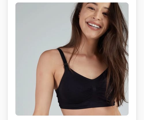 A smiling reviewer wearing the black Lovemère Seamless Nursing Bra, showing its comfortable fit.