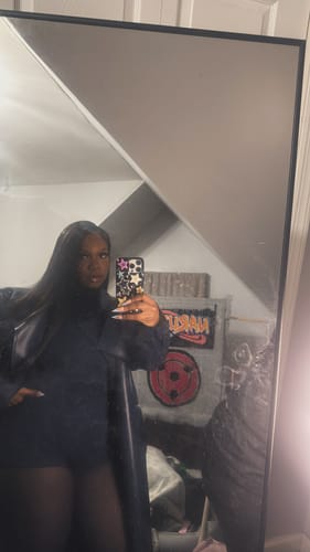 Customer's angled mirror selfie showcasing the black Butter Turtleneck Contour Bodysuit in a bedroom.