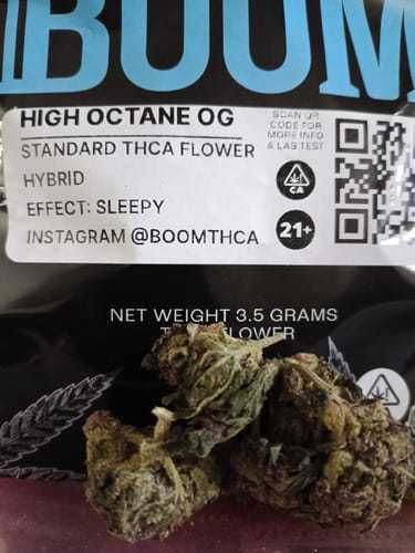 Close-up of a reviewer's High Octane OG buds displayed in front of the black branded packaging.