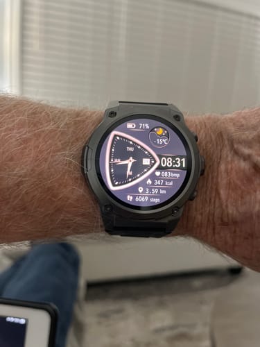 Reviewer wearing the Gard Pro Ultra 3 smartwatch, displaying health and activity metrics on its face.