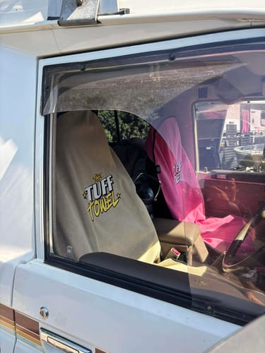 Customer's car with a tan Waterproof Car Towel Seat Cover on the driver's seat and a pink one on the passenger seat.
